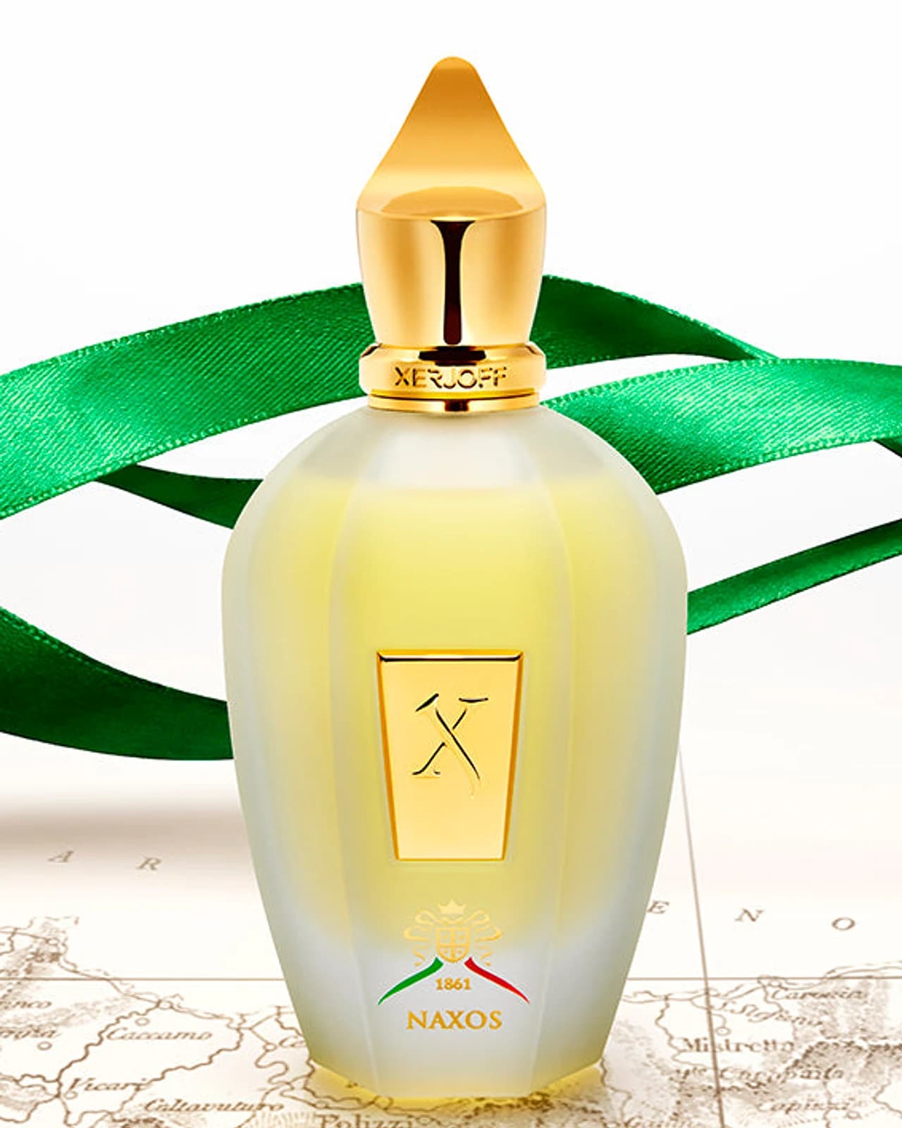 Xerjoff Naxos — the official editorial still, pale glass with a green silk ribbon