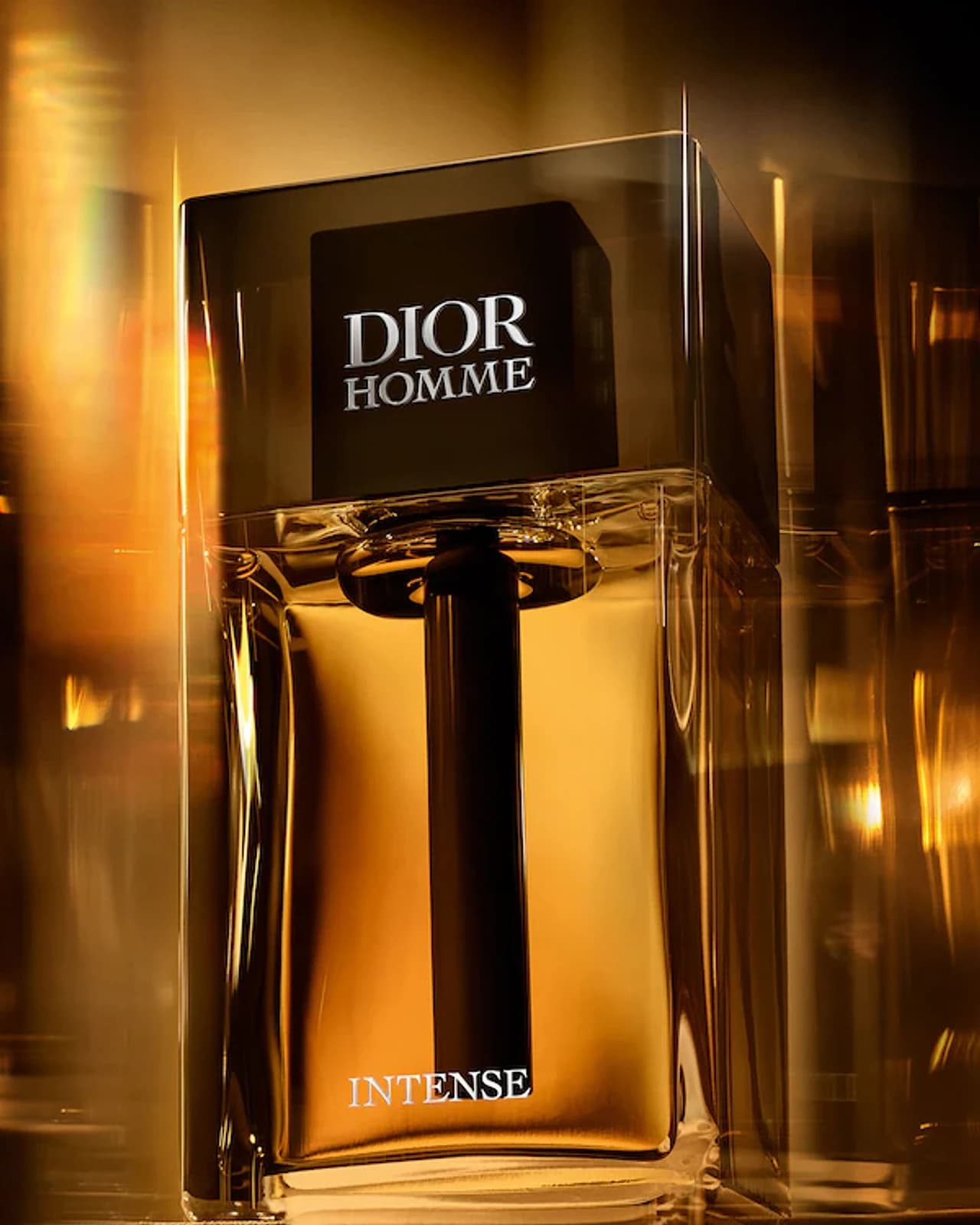 A fragrance bottle held in warm amber light